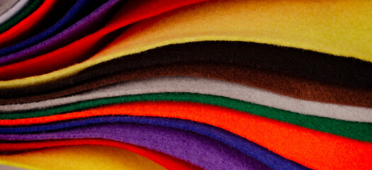 Several colored felt texture background. Assorted color felt fabric sheets, patchwork, sewing DIY...