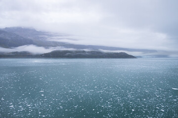 Ice chunks in the water and mountain background at Glacier Bay, Alaska, USA		