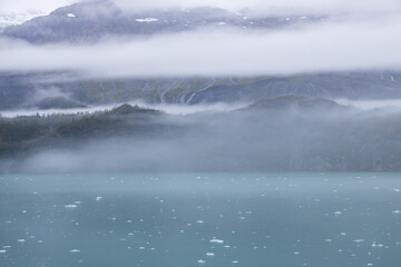 Ice chunks in the water and mountain background at Glacier Bay, Alaska, USA		