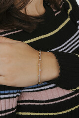 diamond bracelets on the girl's wrist with well-groomed white nail polish. jewelry models for online sale.