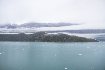 Ice chunks in the water and mountain background at Glacier Bay, Alaska, USA	
