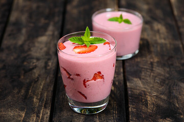 Strawberry smoothie on a wooden background