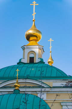 Three Orthodox crosses on a blue sky background.