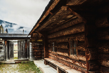 ancient historic brown wooden house and gate overlooking the misty mountains