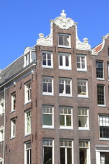 Fototapeta na wymiar Amsterdam Oudezijds Voorburgwal Canal Historic House Facade with Neck Gable, Netherlands
