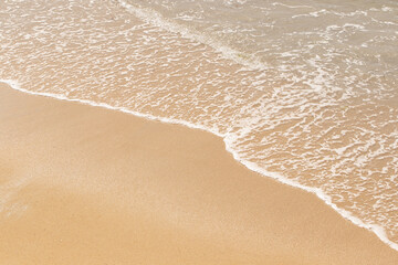 Fototapeta na wymiar abstract background of waves on the beach sand