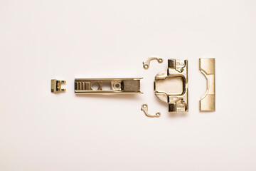 furniture hinge in disassembled form on a white background. top view.