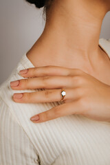 Close-up of an elegant engagement diamond ring on beautiful woman's finger. love and wedding concept. Like the split tone Instragram process.