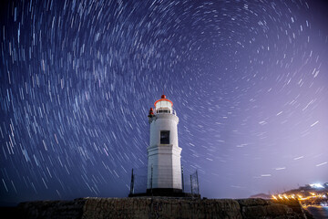Lighthouse Tokarevsky in Vladivostok at night. Starry against the backdrop of a beautiful...
