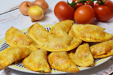Tuna turnovers, homemade, with tomato, bell pepper, egg and other ingredients, freshly baked.