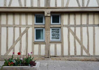 Fototapeta na wymiar Old timbered house wall and window with flowers, Troyes, France 