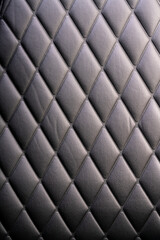 Fototapeta premium Black leather check pattern interior details of modern luxury sport cars. Comfortable leather cockpit seats for background.