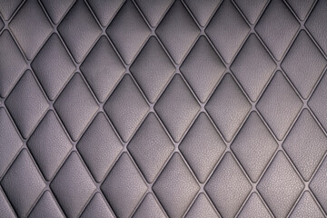 Black leather check pattern interior details of modern luxury sport cars. Comfortable leather cockpit seats for background.