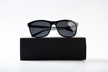 Sunglasses near the black box.