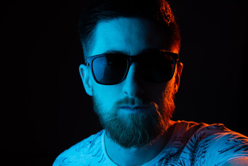 Man in sunglasses in neon light