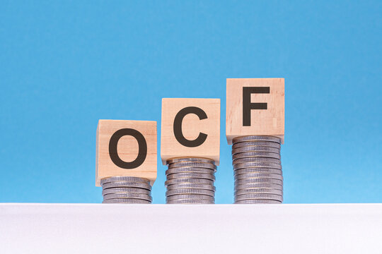 ocf - text on wood cubes stack with coins