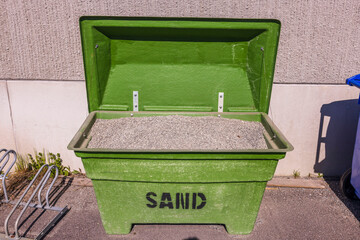 Close up view of an open container with fine gravel for covering  ice roads. Sweden.