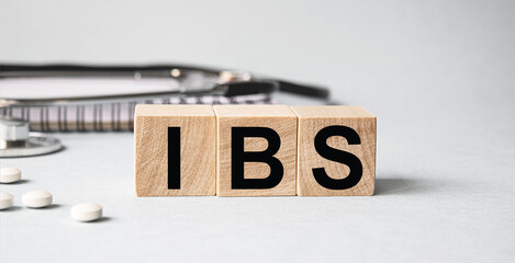 IBS inscription on wooden cubes isolated on white background, medicine concept. Nearby on the table...
