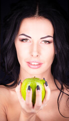Halloween. A terrible wicked witch holds a poisoned apple in her hands, standing in her lair among...