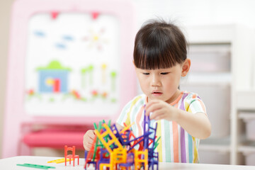 young girl playing balance chairs  toy for homeschooling
