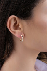 women's earrings with stones, jewelry, earrings at the ear of a beautiful girl, women's accessories, gold earrings, earrings with stones