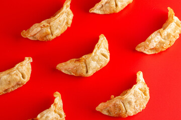 Fototapeta premium Background of Pork Potstickers Dumplings on a Bright Red Background