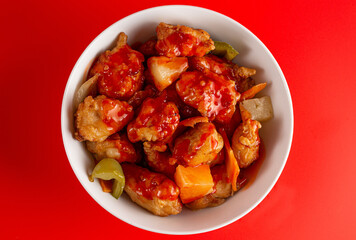 Bowl of Fried Chicken and Vegetables with Sweet and Sour Sauce