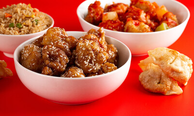 Bowl of Sesame Chicken on a Bright Red Background