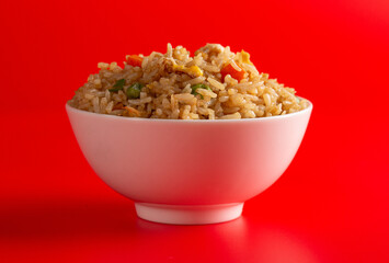 Bowl of Fried Rice on a Red Background