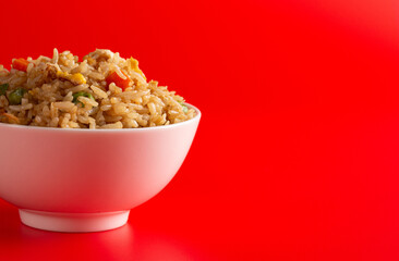 Bowl of Fried Rice on a Red Background