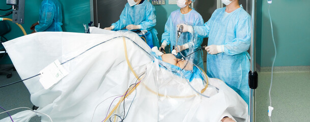 A team of surgeons perform laparoscopic surgery in the operating room. Widescreen image. Banner.
