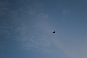 plane in the distance at sunset