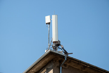GSM mobile phone antenna tower on house roof