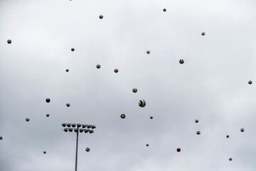 A dramatic sky full of footballs