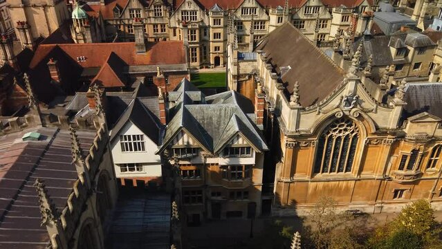 Oxford colleges and rooftops from above. Pan right