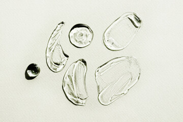 Set of Liquid gel cosmetic smudge texture. Transparent Gel drops on light green background. Serum...