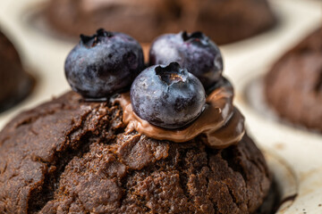 fresh baked muffins with chocolate cream and blueberries in ceramic pan
