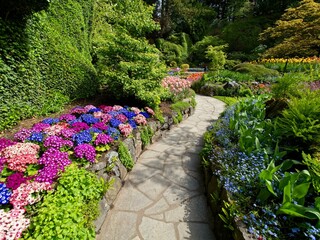 Lush garden blooming in the springtime with tulips, flowerbeds and lawns