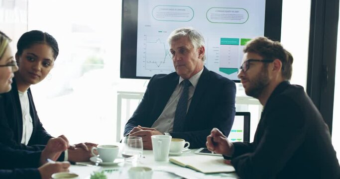 Same goal, different points of view. group of businesspeople having a meeting in the boardroom. Team of serious businesspeople brainstorming during a meeting 