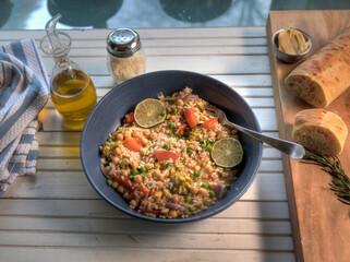 Top View of Brown rice and veggie bowl on natural wood table
