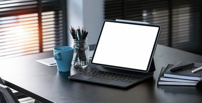 Contemporary business workspace, Workspace digital tablet computer on office desk. Blurred background.