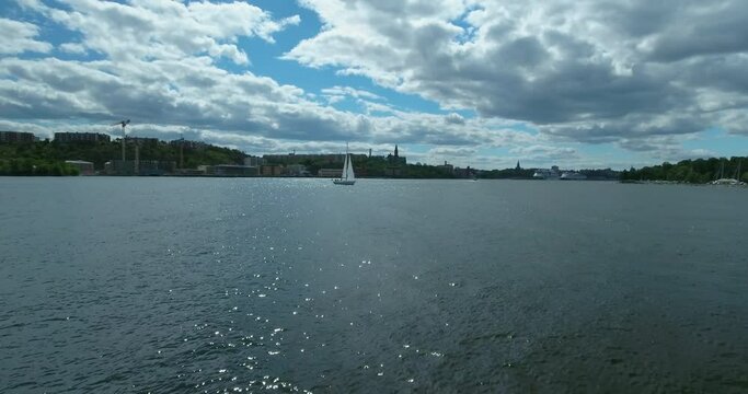 Aerial Shot Of Yacht Moving On Sunny Day, Drone Flying Forward Over Sea - Stockholm, Sweden