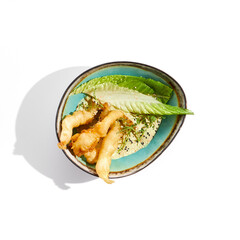 Delicious appetizers - tempura shrimp with peanut sauce. Japanese dish - crispy deep fried prawn. Tempura prawn with asian sauce isolated on white background. Hot deep fried seafood appetizer.