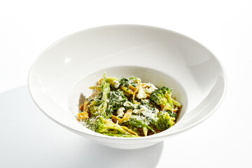 Veggie pasta with broccoli isolated on white background. Vegetarian dish - udon noodle with green vegetables. Vegan food in restaurant menu. Plant based dinning.