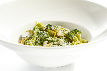 Veggie pasta with broccoli isolated on white background. Vegetarian dish - udon noodle with green vegetables. Vegan food in restaurant menu. Plant based dinning.