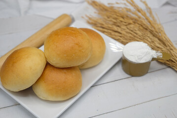 Fresh fragrant bread and bun on the table with copy space. Food concept