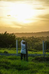 RURAL FARM MAN WORKING WHILE the sunset