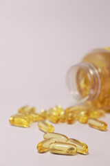  fish oil capsules with omega 3, blurred bottle in background