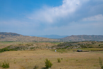 spacious green fields and mountains in georgia in summer