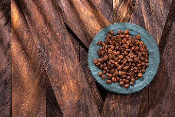 Coffea - Brown roasted coffee beans in the bowl